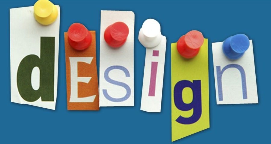 The word design spelled out in cut-paper letters pinned to a board with coloured pushpins